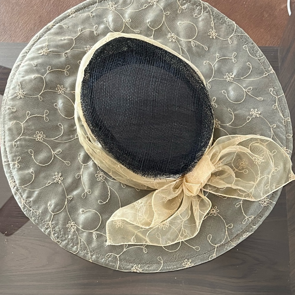 Black straw hat with olive green/beige detailed voile with bow, from saks.